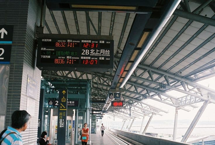 A Taiwan High Speed Rail platform — the bilingual departure board showing the next trains to Taipei, the northbound platform stretching away under the station canopy.