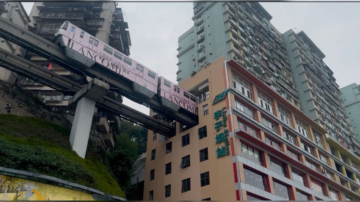 Chongqing's Liziba Station — the pink monorail passing straight through the middle of a residential apartment block.