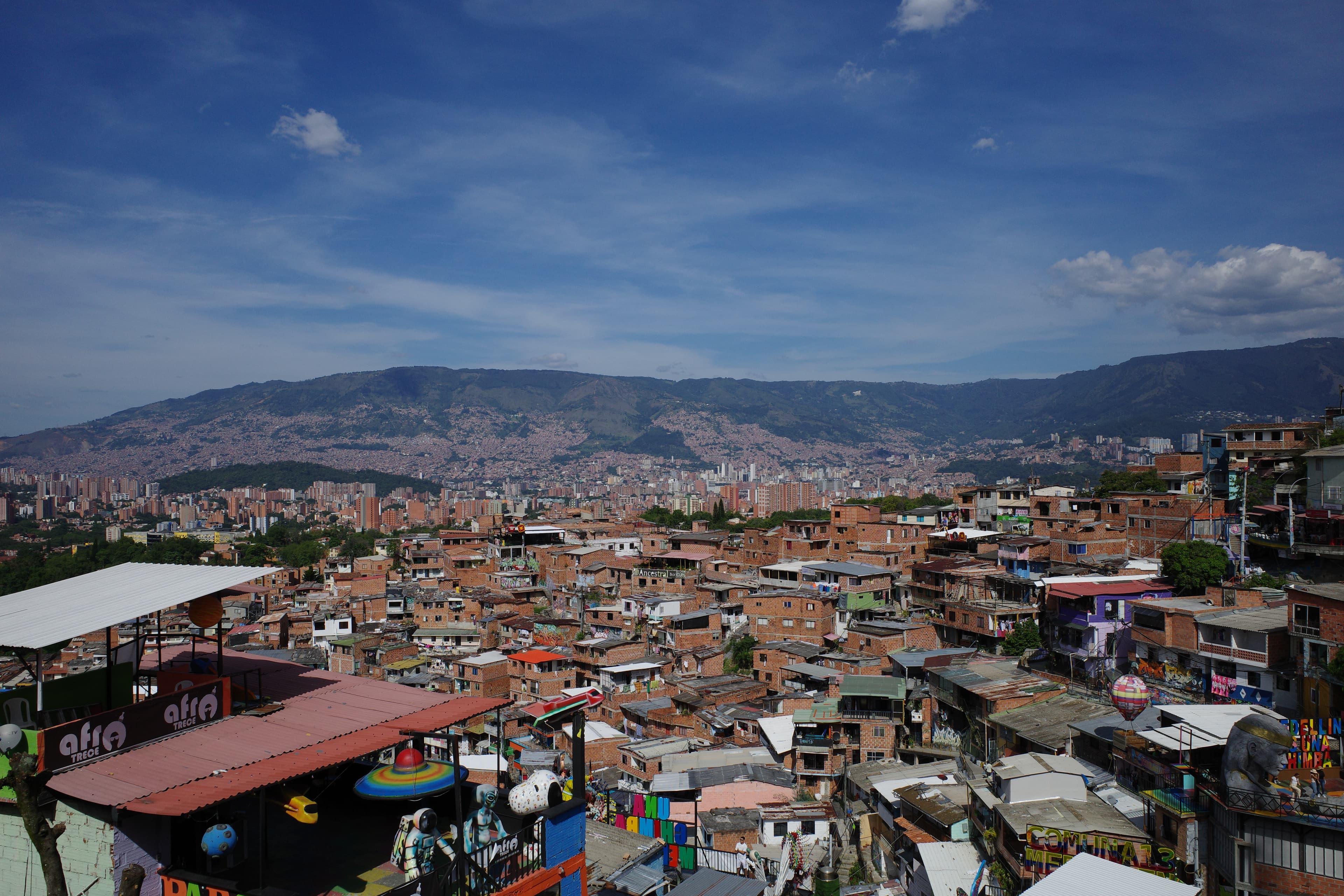 Medellin from above — Comuna 13 in the foreground, the city spilling up the valley.