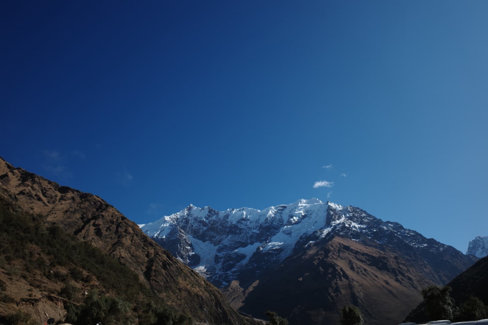 The snow-capped Salkantay massif rising above the brown Andean valley on the Salkantay trek, glaciers catching the morning light.
